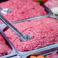 Close-up of fresh meat and minced beef in a retail display at San Vito market, Costa Rica.